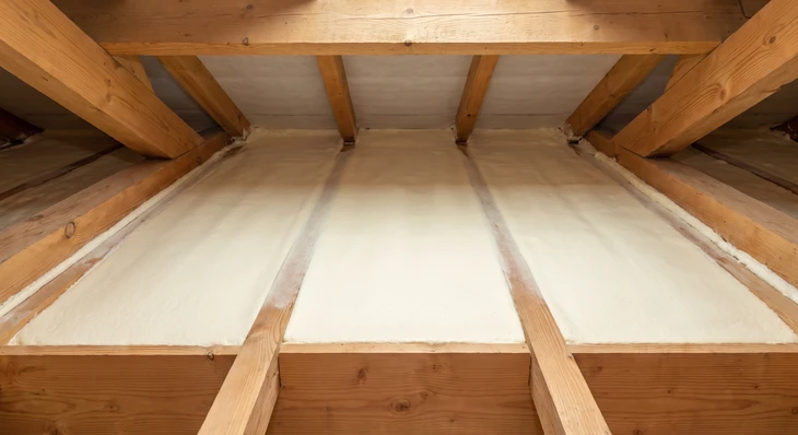 Technicien en combinaison blanche Tyvek intégrale, équipé d'un casque ventilé à adduction d'air, opérant dans un espace confiné protégé par un confinement polyéthylène